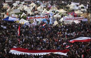 Egyptian protesters attend an opposition rally in Tahrir Square in Cairo. Thousands gather for a protest against Egypt's president in a significant test of whether the opposition can rally the street behind it in a confrontation aimed at forcing the Islamist leader to rescind decrees that granted him near absolute powers.