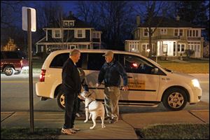 Gil Lutz, right, and his dog, Satchel, arrive by Perrysburg Transit at the municipal building. His ride was the final call-a-ride service offered by the city.