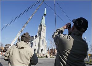 Workers from the Speiker Company install a new steeple on St. Rose Church.
