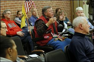 Gregory Symington, who uses a motorized scooter, tells the committee that he has contacted the U.S. Justice Department and is considering filing a lawsuit against the city.