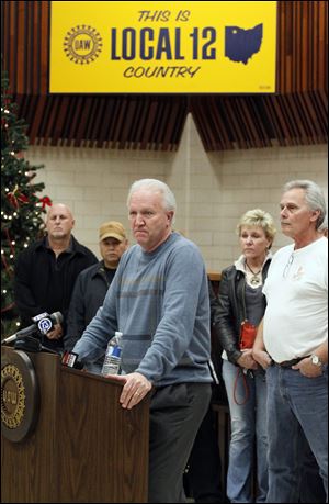 UAW Local 12 President Bruce Baumhower, with Jeep paint shop workers who will lose their jobs Friday, says it will be a long time before his union can trust Chrysler management again.