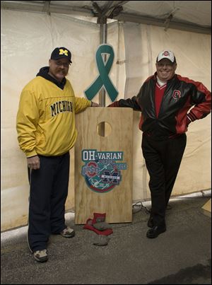 Jason Cowell and Jeff Steinke take on the Border Battle Bash Cornhole Boards.