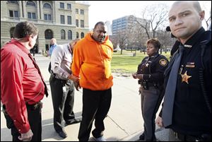 An unidentified man is one of six people taken into custody after a disturbance inside and then outside the Lucas County Courthouse. All were in the county jail Wednesday night.