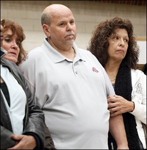Darlene Cole, left, Bob DeShetler, and Dora Martinez, whose jobs are being terminated, listen as UAW Local 12 President Bruce Baumhower tells them Chrysler did not try to save their jobs. Chrysler asked them to retire and work for a Jeep supplier; Chrysler is now taking the work in-house and getting rid of their jobs.