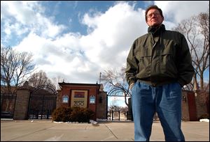 Tim Reichard, outside the Toledo Zoo’s Broadway entrance, was dismissed after more than 22 years as its veterinarian.