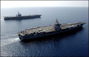 U.S. Navy aircraft carrier USS Enterprise, foreground, steams through the Red Sea with the USS Dwight D. Eisenhower in 2006.