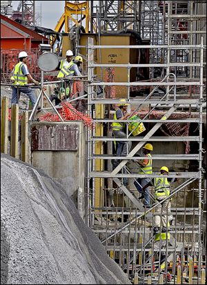 Construction of the new set of locks is 24-hour operation as Panama works towards 2015 completion date. Workers move up the scaffold at the construction site of one of the locks.