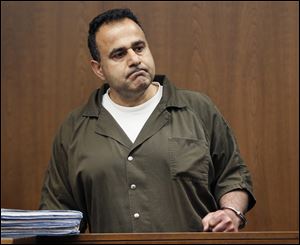 Koray Ergur clenches his fist after becoming argumentative with Judge C. Allen McConnell during an appearance in Toledo Municipal Housing Court, Friday. Ergur, who owns both the downtown Nicholas and Spitzer buildings, was arrested Thursday and placed in jail pending for fire department order violations. 