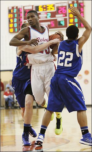 Bowsher's Dajuan King drives against Springfield's Marquan Hodges in last night's season opener.