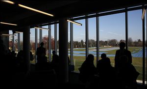 Students mingle near the large glass windows in the Student Achievement Center that overlook the track. The center was created by combining two classrooms and the library. It was built as an addition to the main building.