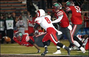 Central Catholic running back Amir Edwards scores a touchdown against Trotwood-Madison during the second quarter during the Division II state football championship at Paul Brown Tiger Stadium in Massillon, Ohio.