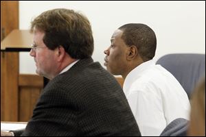 Daurin Patton, right, who is charged with two counts of aggravated murder and aggravated robbery for the shooting deaths of a mother and her teenage son, sits next to his attorney Merle Dech, left,  at the Lucas County Courthouse on November 26, 2012.