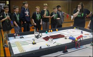 Maumee St. Joseph Elementary School captain Taylor Gallardo, right, and her team watch their robot maneuver through obstacles during the competition.