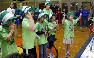 Melanie Gromes, right, a fourth grader at Sylvan Elementary, cheers on her  team's robot.