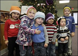 Modeling hats collected at Love ’n’ Learn day care are, from left: Lucy Printke, Mayley and Crosby Mannebech, Riley Clegg, and Mackston and Maddock Robson.