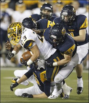 Cincinnati Moeller'S Joe Eramo, 23, is tackled by Whitmer'S Jack Linch, 44, Al Bryant, IV and Devin Thomas, 1, during the second quarter Saturday.