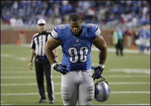 Detroit Lions defensive tackle Ndamukong Suh walks off the field after the Lions lose 35-33 to the Indianapolis Colts in an NFL football game at Ford Field in Detroit, Sunday, Dec. 2, 2012. 