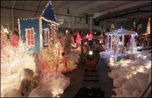 Youngsters ride the train through a Christmas display at Children’s Wonderland at Tam-O-Shanter. The traditional event, which opened Saturday, is in its third year at the Sylvania site.