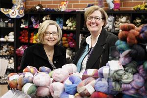 Knitters spend hours in the shop of Candice Fink, left, of Sylvania and Tracey Maris of  Toledo, working on projects and sharing advice.
