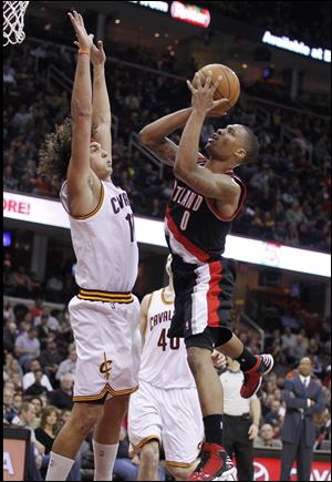 Portland Trail Blazers' Damian Lillard (0) shoots over Cleveland Cavaliers' Anderson Varejao (17), from Brazil, in the third quarter Saturday. Lillard scored a team-high 24 points in the Trail Blazers' 118-117 win. 
