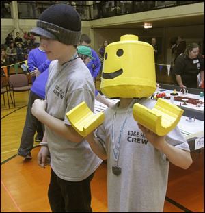 Edgewater Elementary students Layne Murphy and Kevin Reynolds watch their robot perform.