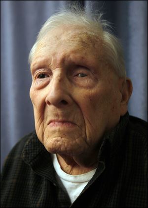Paul Fisher, 99, poses for a portrait at Franciscan Care Center in Toledo. He celebrated his 100th birthday on Saturday.