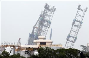 A backup rig is seen tilted to one side off a shipyard in Singapore. The ministry of manpower reported that about 90 workers were sent to hospitals after a jackup rig at a shipyard in Singapore tilted to one side.