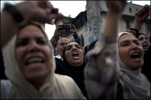 Egyptian protesters chant anti-Muslim Brotherhood slogans during a rally in front of the presidential palace in Cairo.