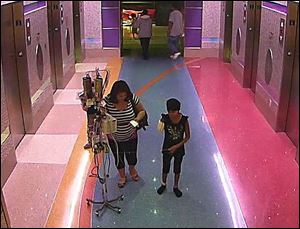 In this hospital surveillance photo released by the Phoenix Police Department, a woman is seen with her 11-year-old daughter, a leukemia patient who had her arm amputated and a heart catheter inserted due to an infection. 