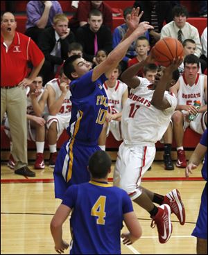 Findlay's Grant Niswander tries to block shot of Bowling Green's LaMonta' Stone.