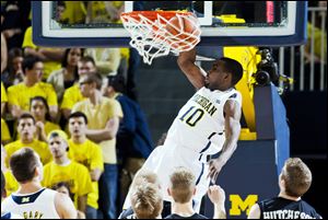 Michigan guard Tim Hardaway, Jr., dunks the ball in the first half of an  against Western Michigan on Tuesday at Crisler Center in Ann Arbor.