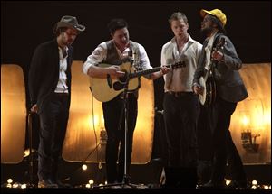 Mumford and Sons perform on stage for the Brit Awards 2011 at The O2 Arena in London. Mumford and Sons is among the six nominees with a leading six nods for the 55th annual Grammy Awards, announced Wednesday night.