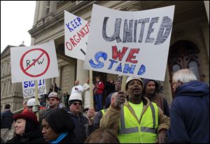 Union workers rally outside the Capitol in Lansing, Mich., as Senate Republicans introduced right-to-work legislation in the waning days of the legislative session. The outnumbered Democrats pledged to resist the proposal and said rushing it through the legislative system would poison the state's political atmosphere.