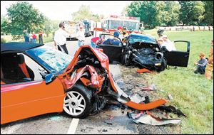 This head-on crash near Granville in central Ohio killed two occupants of the red Chevrolet Camaro, foreground, and injured the driver of the black Volkswagen Beetle in 2001. The crash happened on State Rt. 37, which has the highest fatality rate of any major Ohio route.