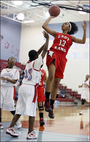 Rogers forward Toriana Easley, who had 19 points, goes to the basket against Bowsher's Shai-kaila Smith.