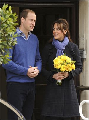Britain's Prince William stands next to his wife Kate, Duchess of Cambridge as she leaves the King Edward VII hospital in central London on Thursday.