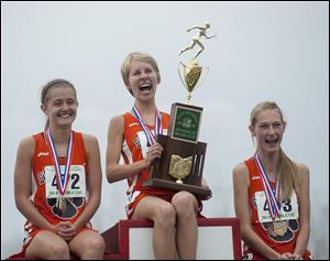 Two trips, two big trophies for the Liberty Center girls cross country team, which gave the school back-to-back state championships.