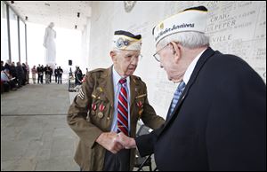 Pearl Harbor survivors Max Green, left,  and Bill Thornton greet each other prior to the Pearl Harbor Day Remembrance Ceremony at the Va. War Memorial, in Richmond, Va. on Friday.