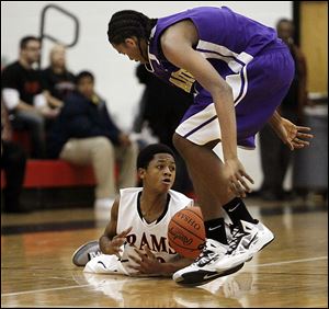 Rogers' Kevon tries in vain to gain control the ball during the third quarter of the Rams' game against the Waite Indians at Rogers High School. Rogers won 110-44.
