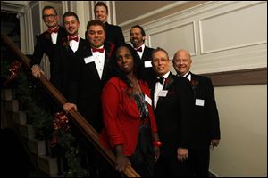 Committee Members for the Holiday with a Heart Charity Gayla line up for a picture on the stairs of The Toledo Club in Toledo.  Pictured are, front row, top to bottom of stairs, are Wayne North, Andrew Larsen, Rick Cornett, and Kenyetta White, and in the back row, Billy Man, Steve Manley, Ed Hoffman, and David Bringham.