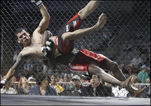 Matt Montalvo is tossed to the mat by Donte Adams during their fight at the Purgatory Fight Series 10 event at the Huntington Center. Montalvo won the fight.