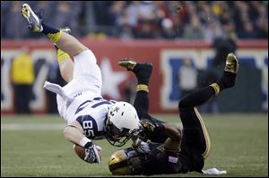Navy's Matt Aiken, left, is upended on a tackle by Army's Josh Jackson during the first half Saturday in Philadelphia.