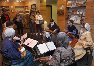The Back Porch Dulcimer Band plays holiday music as visitors tour Fort Meigs in Perrysburg.