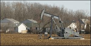 An oil well operates on a site near Hunt Road and Lenawee Hills Highway near Adrian. A combined 1.6 million barrels were drawn last year from the Adrian field and Napoleon Township oil field in the Irish Hills region.