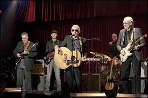 Graham Parker, center, appears in a scene from the Universal Pictures film, 'This is 40,'  written, co-produced and directed by Judd Apatow. 