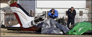 Investigators photograph a plane crash at Munson Park Tuesday, 3/30/11, in Monroe, Michigan.