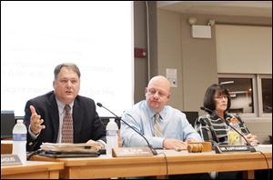 Oregon Superintendent Michael Zalar, left, says reconfiguring grades five through eight would address  underperforming  classes. With him are board members P.J. Kapfhammer and Carol-Ann Molnar.