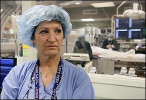 Surgical nurse Olivia Cox is back on the job.  A casual conversation with a vascular surgeon led to discovery of her cerebral aneurysm.