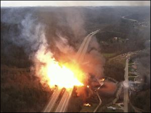 This image provided by the West Virginia State Police shows a fireball erupting across Interstate 77 from a gas line explosion in Sissonville, W. Va., Tuesday.