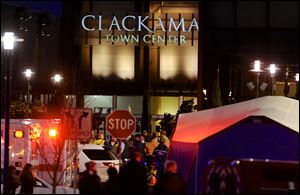 Police and medics work the scene of a multiple shooting at Clackamas Town Center Mall in Portland, Ore., Tuesday .